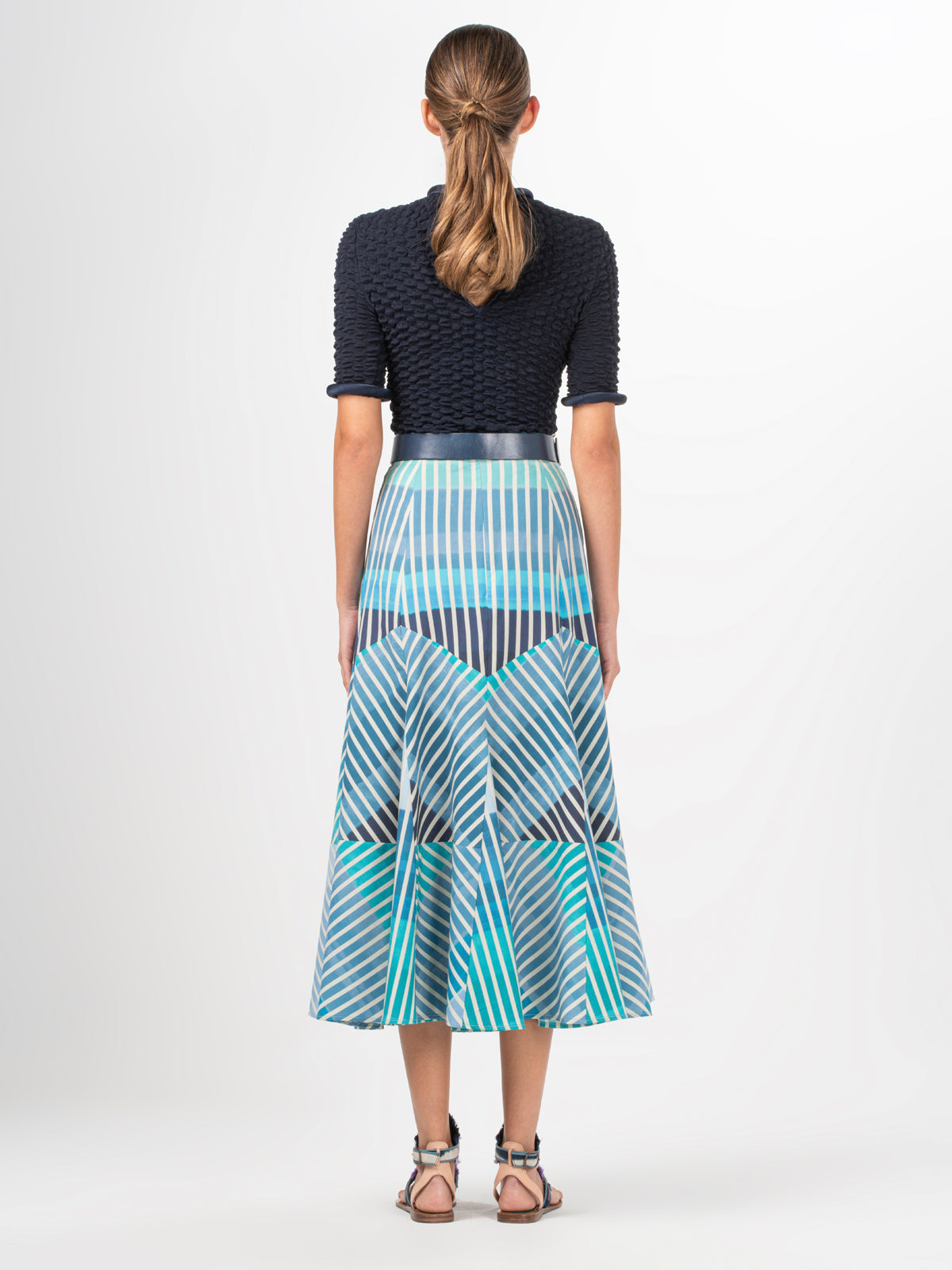 A Madaini Skirt Infinite Blue Stripes with a multicolor stripe pattern.
