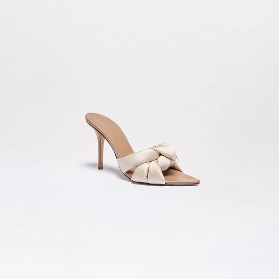 The Ana Heels are high-heeled sandals featuring a slim stiletto heel, open toe, and a large cream knotted strap across the front, displayed against a plain white background.