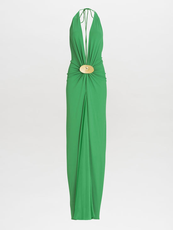 The Aiko Dress is a green halter-neck style featuring a central cutout and accented with a circular gold ornament.